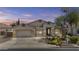 Inviting single-story home with desert landscaping and two-car garage offers suburban charm at 9733 W Hedge Hog Pl, Peoria, AZ 85383