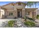Inviting home exterior featuring a landscaped walkway leading to a covered front porch at 9733 W Hedge Hog Pl, Peoria, AZ 85383
