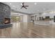 Open living space with fireplace, wood floors, and kitchen access at 9733 W Hedge Hog Pl, Peoria, AZ 85383