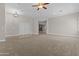 Spacious living room with carpet and a view of the stone fireplace at 9733 W Hedge Hog Pl, Peoria, AZ 85383