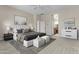 Inviting primary bedroom featuring a neutral palette, stylish furnishings, and an ensuite bathroom at 9733 W Hedge Hog Pl, Peoria, AZ 85383