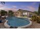 Backyard pool with waterfall feature, patio, and mature landscaping, perfect for outdoor living at 9733 W Hedge Hog Pl, Peoria, AZ 85383