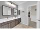 Bathroom featuring dual sinks, modern fixtures, and an elegant design at 10749 E Nido Ave, Mesa, AZ 85209