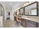 Large bathroom with dual vanity sinks and dark wood cabinets at 10749 E Nido Ave, Mesa, AZ 85209