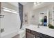 Bright bathroom with a combination tub and shower, and stylish vanity with ample counter space at 10749 E Nido Ave, Mesa, AZ 85209