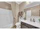 The full bathroom has an enclosed shower and tub and a stylish vanity at 10749 E Nido Ave, Mesa, AZ 85209