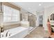 Bright bathroom with a separate tub and shower, along with a large window at 10749 E Nido Ave, Mesa, AZ 85209