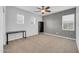 Neutral bedroom with multiple windows, ceiling fan and a dedicated desk and bookshelf area at 10749 E Nido Ave, Mesa, AZ 85209