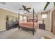 Bedroom featuring a four-poster bed, ceiling fan, and neutral decor at 10749 E Nido Ave, Mesa, AZ 85209