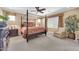 Spacious bedroom featuring a four-poster bed, neutral tones, and cozy carpeting at 10749 E Nido Ave, Mesa, AZ 85209