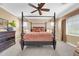Bedroom with a four-poster bed, ceiling fan, and carpet flooring at 10749 E Nido Ave, Mesa, AZ 85209