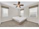 Bright bedroom with a ceiling fan, a bed, and natural light at 10749 E Nido Ave, Mesa, AZ 85209