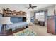 Cozy bedroom with bunk beds, a ceiling fan, a window desk, and a playful rug at 10749 E Nido Ave, Mesa, AZ 85209