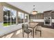 Sunlit breakfast nook with dark wood cabinets and a large window overlooking the manicured yard at 10749 E Nido Ave, Mesa, AZ 85209