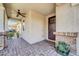 Inviting covered front porch with brick pillars and a ceiling fan at 10749 E Nido Ave, Mesa, AZ 85209