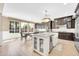 Bright, open kitchen featuring an island with a farmhouse sink and bar seating at 10749 E Nido Ave, Mesa, AZ 85209
