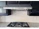 The kitchen features a stainless steel hood vent and range with light tile backsplash and granite countertop at 10749 E Nido Ave, Mesa, AZ 85209