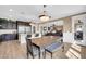 Open kitchen with stainless steel appliances, large island and breakfast bar at 10749 E Nido Ave, Mesa, AZ 85209