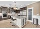 Gourmet kitchen features an island with bar seating and a stainless refrigerator at 10749 E Nido Ave, Mesa, AZ 85209