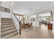 Bright living room with wood floors, staircase, and dining area at 10749 E Nido Ave, Mesa, AZ 85209