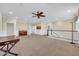Spacious loft area featuring neutral colors and an open layout with a piano at 10749 E Nido Ave, Mesa, AZ 85209