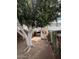 A shady backyard featuring a large tree, a shed, and fenced yard at 2533 W Rose Ln # A8, Phoenix, AZ 85017
