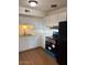 Bright kitchen features white cabinetry, laminate countertops, and modern appliances at 2533 W Rose Ln # A8, Phoenix, AZ 85017
