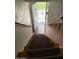 View down the carpeted stairs leading toward the front door at 2533 W Rose Ln # A8, Phoenix, AZ 85017