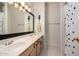 Well-lit bathroom with a double sink vanity, shower with patterned curtain, and cat accents at 3713 E Encinas Ave, Gilbert, AZ 85234