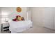 Bright bedroom featuring neutral walls, carpet, and a decorative sun accent over the bed at 3713 E Encinas Ave, Gilbert, AZ 85234