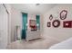 Cozy bedroom with soft carpet, a dresser with lamps and various framed mirrors at 3713 E Encinas Ave, Gilbert, AZ 85234