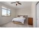 Inviting bedroom with a natural wood bedframe, modern headboard and large window at 3713 E Encinas Ave, Gilbert, AZ 85234