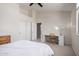Spacious bedroom with a ceiling fan, vaulted ceilings and a built-in desk area at 3713 E Encinas Ave, Gilbert, AZ 85234