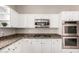 Bright kitchen featuring white cabinets, granite countertops, and stainless steel appliances at 3713 E Encinas Ave, Gilbert, AZ 85234