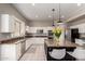 Bright kitchen with an island, stainless appliances, and granite countertops at 3713 E Encinas Ave, Gilbert, AZ 85234