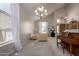 Bright living room featuring high ceilings, natural light, plush carpet, and an upright piano at 3713 E Encinas Ave, Gilbert, AZ 85234