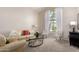 Sunlit living room with neutral walls, carpet flooring, and comfortable seating at 3713 E Encinas Ave, Gilbert, AZ 85234