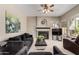 Comfortable living room with cozy fireplace, TV, and plush seating at 3713 E Encinas Ave, Gilbert, AZ 85234