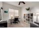 Home office featuring a modern desk, bookcase and comfortable seating area by the window at 3713 E Encinas Ave, Gilbert, AZ 85234