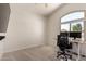 Bright home office featuring a desk with two monitors, a chair, and large arch window at 3713 E Encinas Ave, Gilbert, AZ 85234