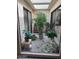 Sunlit atrium featuring decorative plants and stone ground cover at 5322 N 78Th St, Scottsdale, AZ 85250