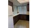 Well-lit kitchen with black appliances, wood cabinets and shutters at 5322 N 78Th St, Scottsdale, AZ 85250