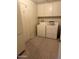 Functional laundry room includes a white washer and dryer and built-in storage cabinets at 5322 N 78Th St, Scottsdale, AZ 85250
