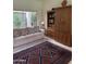Inviting living room with a plush sofa, area rug, and built-in bookcase at 5322 N 78Th St, Scottsdale, AZ 85250