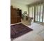 Comfortable living room featuring a sofa, shutter doors, and large Persian rug on carpeted floor at 5322 N 78Th St, Scottsdale, AZ 85250