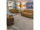 Living room with large mirror, woven wicker chair, and tan and yellow striped sofa at 5322 N 78Th St, Scottsdale, AZ 85250