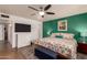 Well-lit bedroom with a large bed, accent wall, and ceiling fan at 5410 E Duncan St, Mesa, AZ 85205