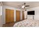 Bright bedroom with natural light, ceiling fan, and closet space at 5410 E Duncan St, Mesa, AZ 85205