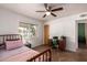 Bedroom with window view, desk, and ceiling fan at 5410 E Duncan St, Mesa, AZ 85205