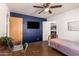 Bedroom with dark accent wall, closet, and ceiling fan at 5410 E Duncan St, Mesa, AZ 85205